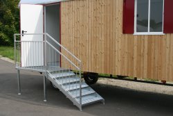 5-step galvanized stairway suitable for children with step-through protection and a platform in front of the side entryway.