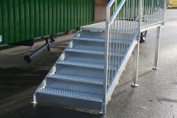 5-step galvanized stairway suitable for children with step-through protection and a platform in front of the side entryway.