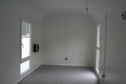 Optional inner wall paneling made of 10 mm chipboard, white. Large, plastic windows down to the floor, and the left window can be used as an emergency exit.