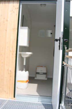 Example of separate toilet compartment accessible from outside with a chemical toilet.