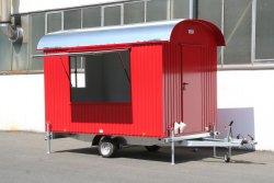 <h5>WEIRO® sales trailer</h5>with 3.50 m body length, outer paneling made of galvanized, painted profile sheet steel, overhead door on side, and entryway over the drawbar.