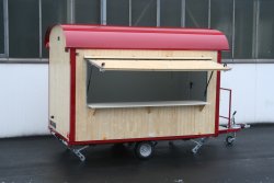 <h5>WEIRO® sales trailer</h5>with 3.50 m body length, wood outer paneling, overhead door on side with small, foldable counter, entryway over the drawbar.