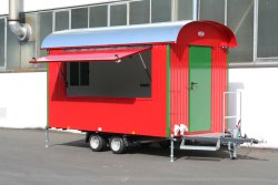 <h5>WEIRO® sales trailer</h5>with 4 m body length, tandem chassis, outer paneling made of galvanized, painted sheet steel, overhead door on side, and entryway over the drawbar.